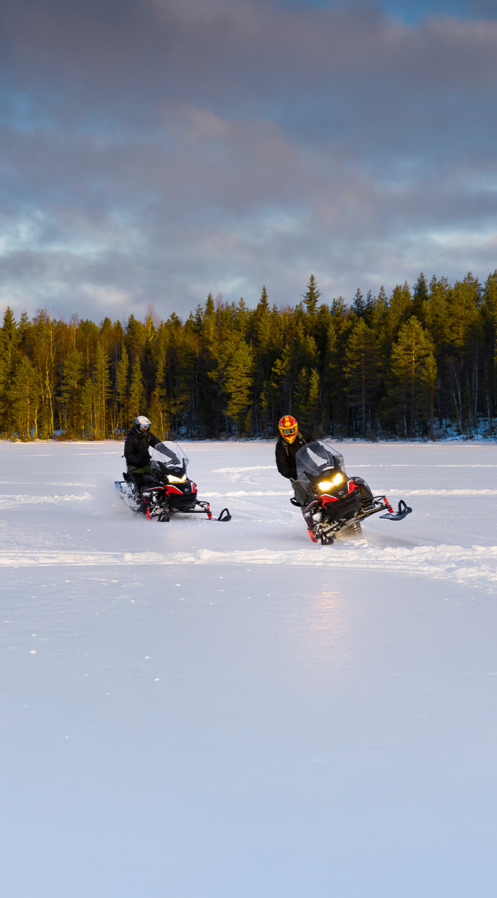 Snowmobiles by Day, Northern Lights by Firelight